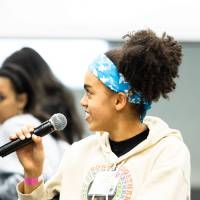 Girls of Color Summit previous event and a women holding a microphone